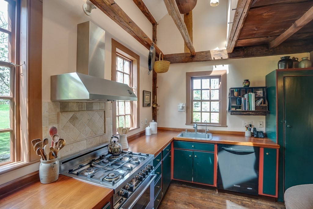 83 Whitney Road Harvard, MA 01451 - Photo 22 of 41 a kitchen with granite countertop a stove and a wooden floors