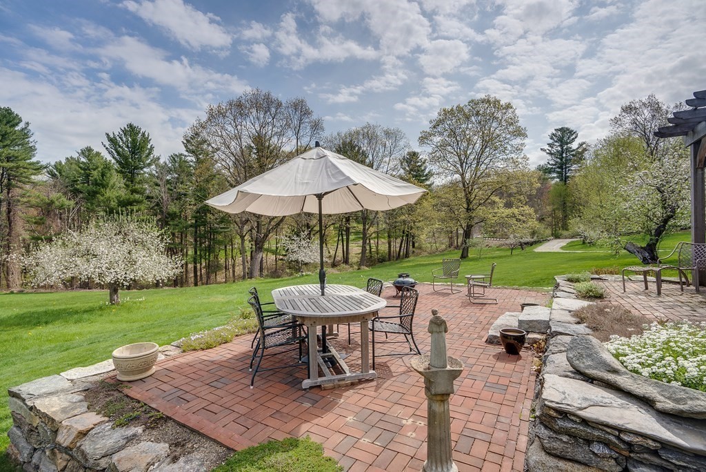 83 Whitney Road Harvard, MA 01451 - Photo 8 of 41 an outdoor space with furniture and umbrella