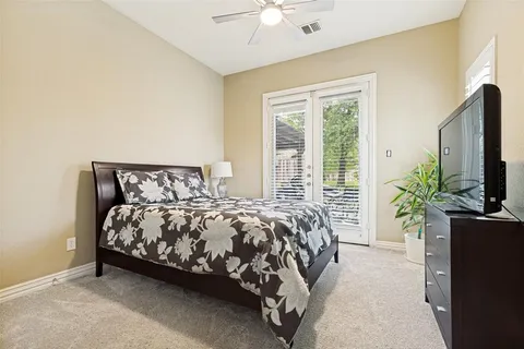 a bed sitting in a spacious bedroom next to a window