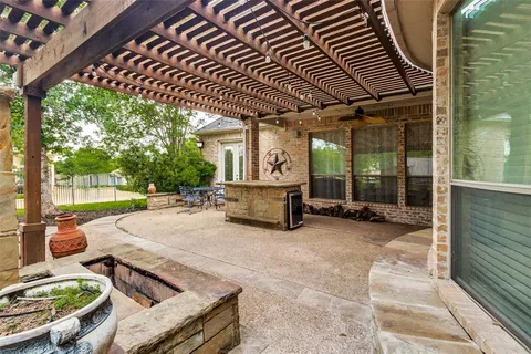 a view of a patio with table and chairs floor to ceiling window with wooden fence
