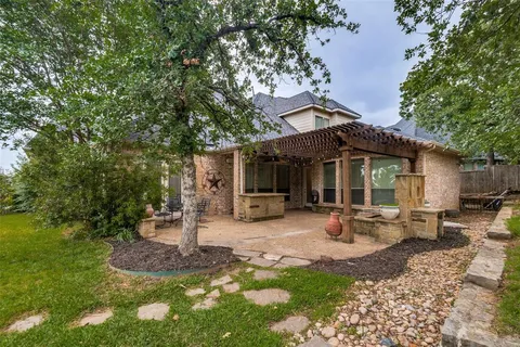 a view of a house with backyard sitting area and garden