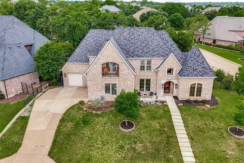 a aerial view of a house with yard