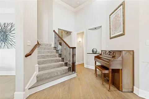 a view of a hallway with wooden floor and staircase