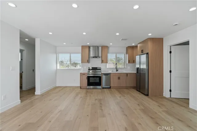 a kitchen with a refrigerator and a stove top oven