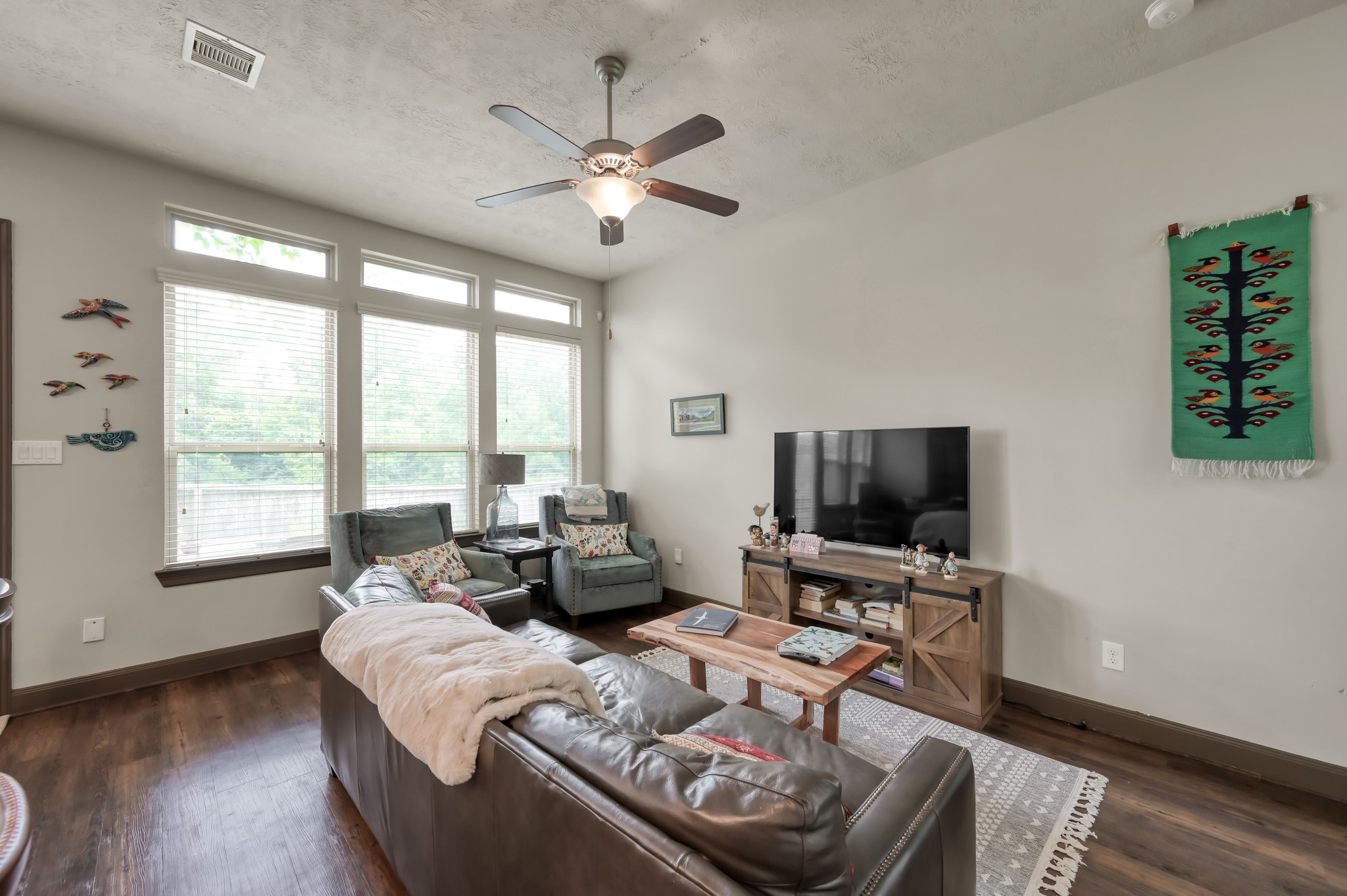 18 Aventura Place Spring, TX 77389 - Photo 10 of 43 a living room with furniture a flat screen tv and a large window