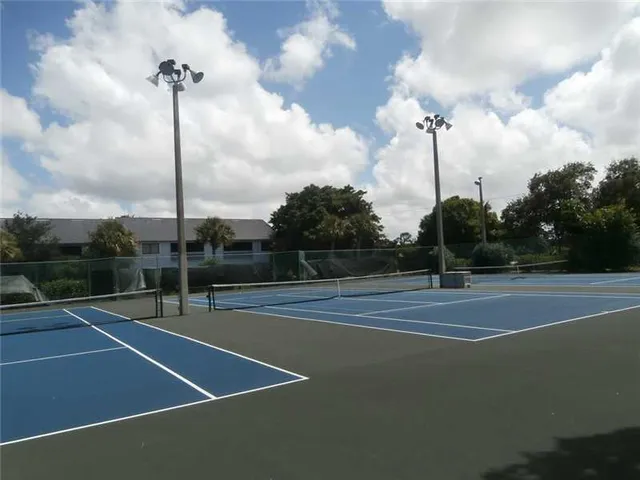 a view of a tennis court with a fountain