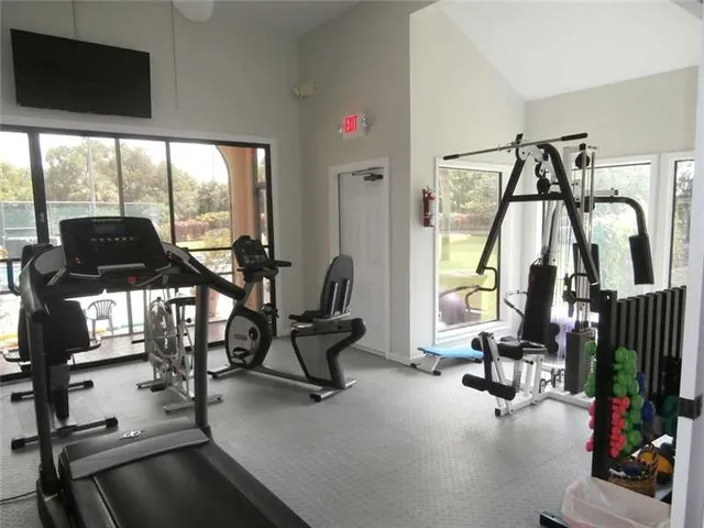 a view of a livingroom with furniture and floor to ceiling window