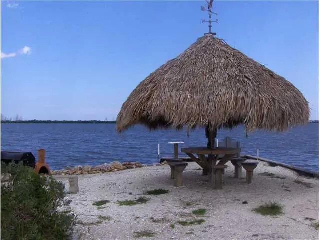 a backyard of a house with table and chairs