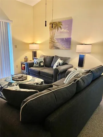 a living room with furniture and a lamp