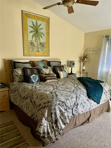 a bedroom with a bed and a painting on the wall