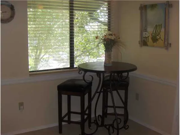 a view of a dining room with furniture and window