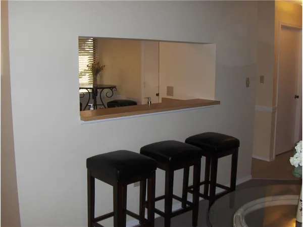 a view of a dining room with furniture and window