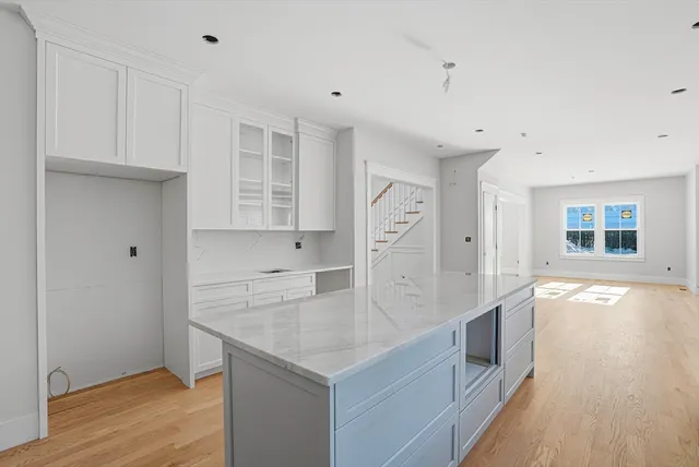 a view of an empty room with a window and fireplace