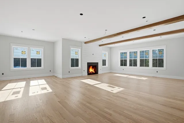 a living room with fireplace furniture and a window
