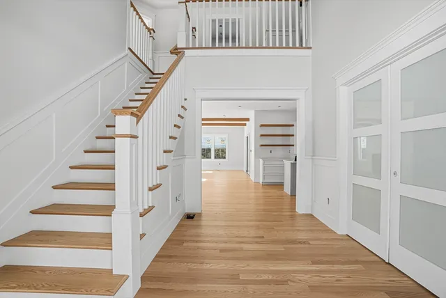 a view of entryway and hall with wooden floor