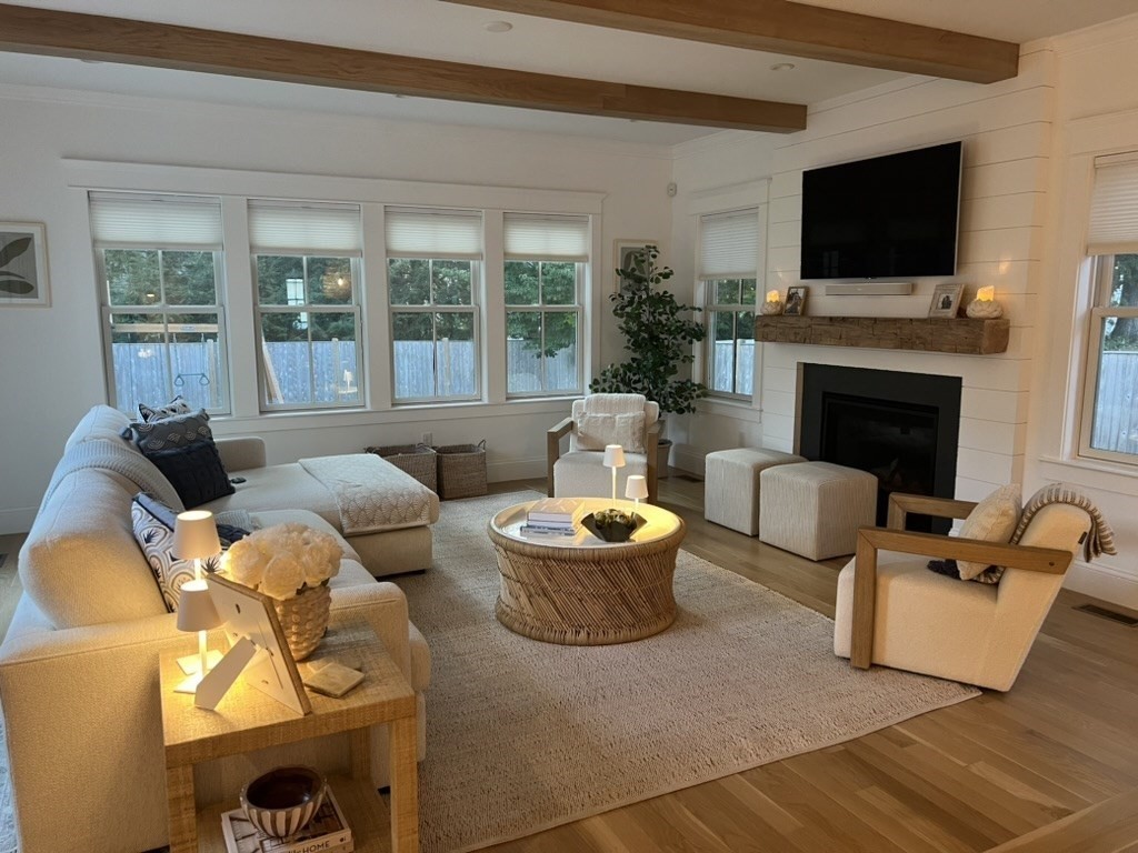 6 Sawmill Brook Lane Upton, MA 01568 - Photo 5 of 10 a living room with furniture a fireplace and a flat screen tv