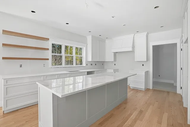 a view of cabinets with wooden floor and window
