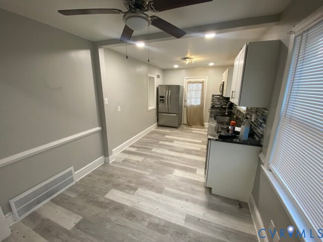 3603 Reynolds Road Richmond, VA 23223 - Photo 6 of 25 Kitchen with white cabinets, stainless steel fridg