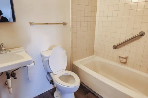 a bathroom with a sink a toilet and bathtub
