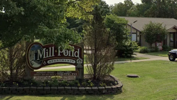 a view of a house with swimming pool and garden