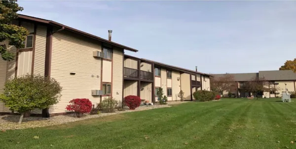 a front view of a house with a garden and yard