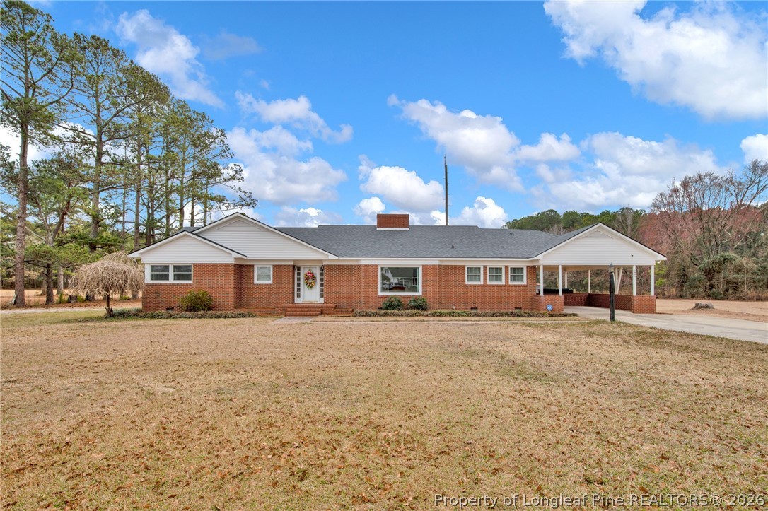 1064 Bainbridge Road Stedman, NC 28391 - Photo 1 of 46 a front view of a house with a yard and garage