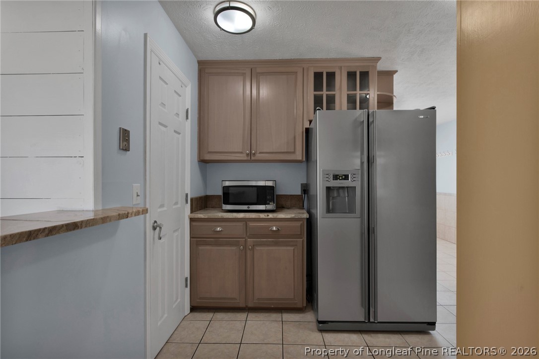 1064 Bainbridge Road Stedman, NC 28391 - Photo 11 of 46 a kitchen with stainless steel appliances granite countertop a refrigerator and a stove