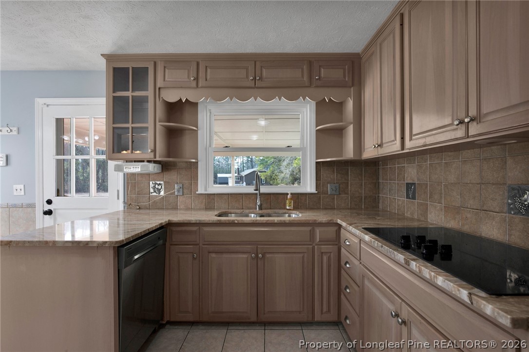 1064 Bainbridge Road Stedman, NC 28391 - Photo 12 of 46 a kitchen with stainless steel appliances granite countertop a sink stove and cabinets