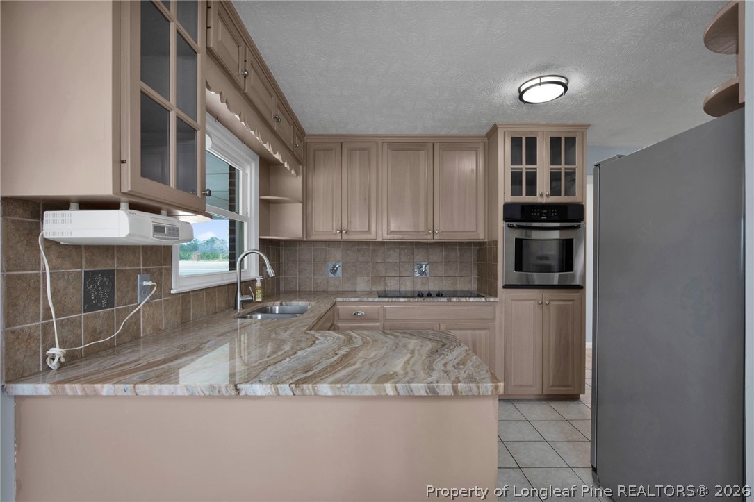 1064 Bainbridge Road Stedman, NC 28391 - Photo 13 of 46 a kitchen with stainless steel appliances granite countertop a sink and cabinets