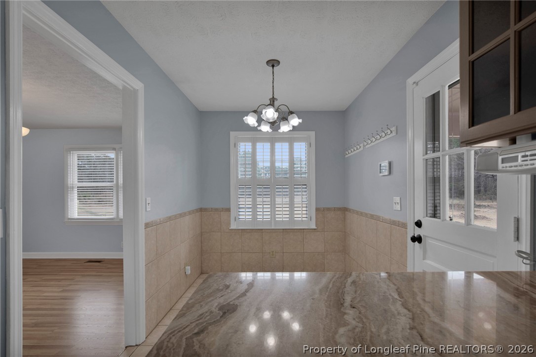 1064 Bainbridge Road Stedman, NC 28391 - Photo 16 of 46 a view of an empty room with window and wooden floor