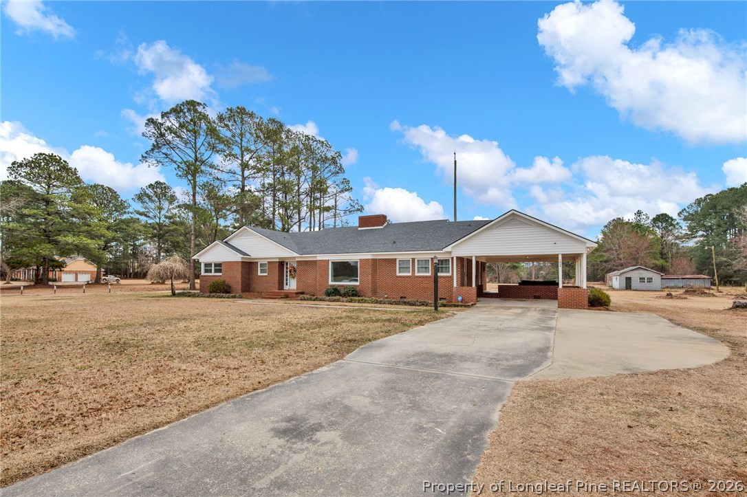 1064 Bainbridge Road Stedman, NC 28391 - Photo 2 of 46 a view of a house with a snow yard and large trees