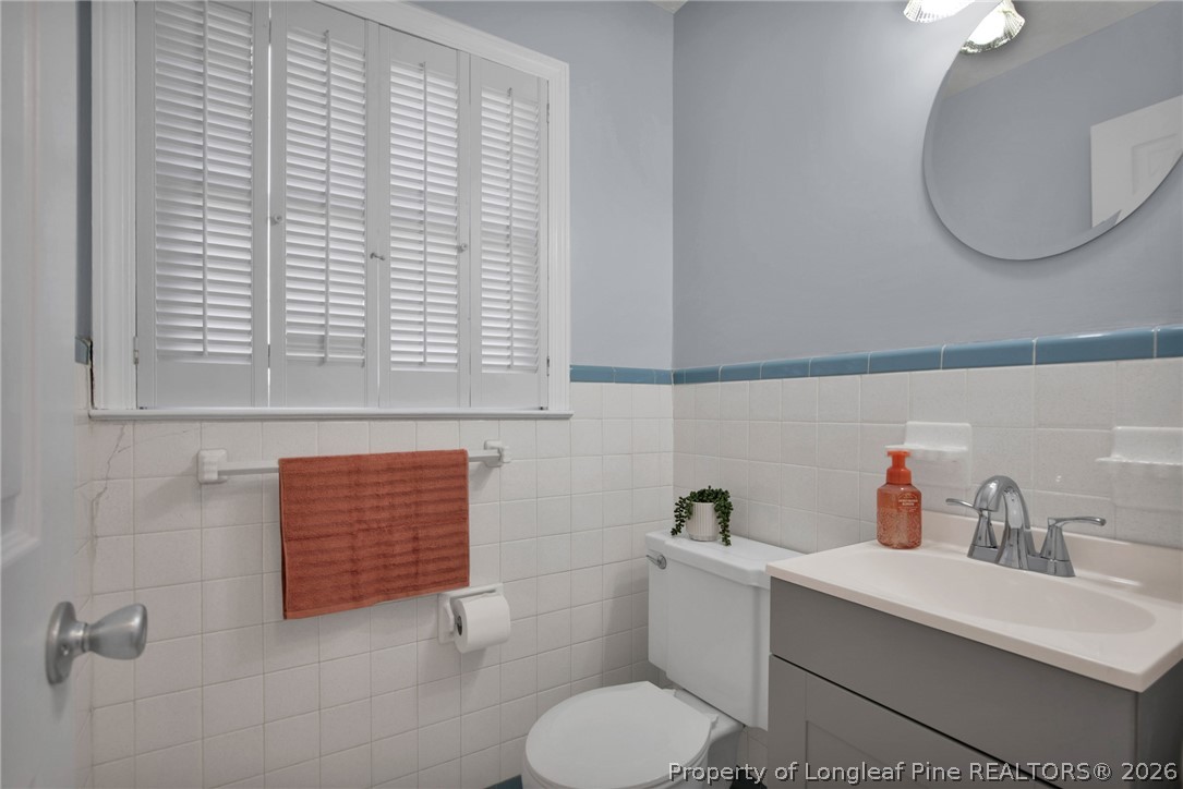 1064 Bainbridge Road Stedman, NC 28391 - Photo 21 of 46 a bathroom with a toilet a sink and a mirror