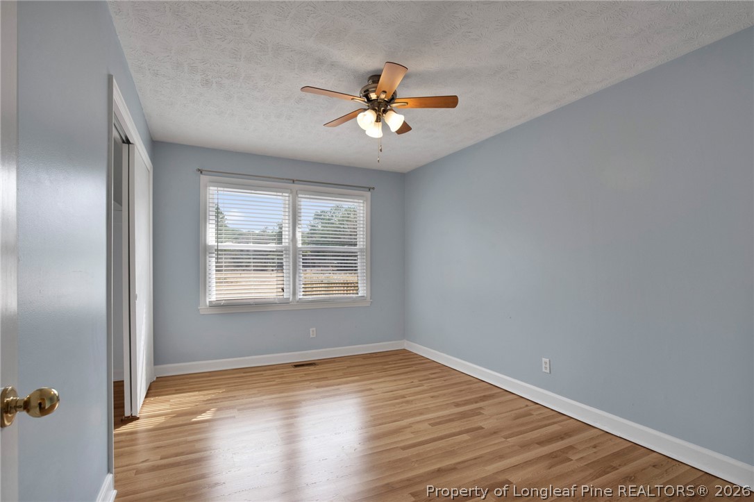 1064 Bainbridge Road Stedman, NC 28391 - Photo 22 of 46 a view of empty room with wooden floor and fan