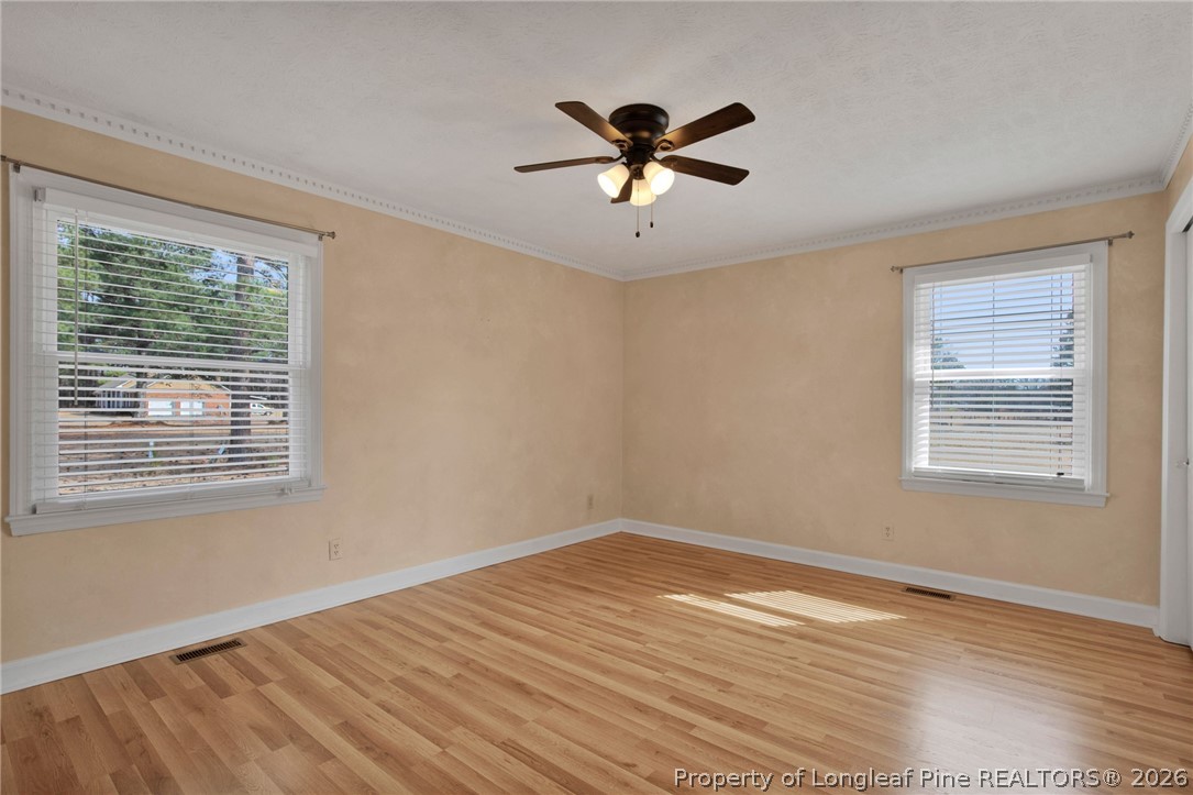 1064 Bainbridge Road Stedman, NC 28391 - Photo 25 of 46 a view of empty room with wooden floor and fan