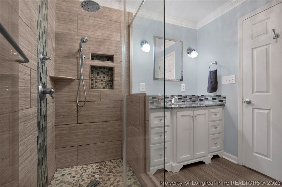 1064 Bainbridge Road Stedman, NC 28391 - Photo 31 of 46 a bathroom with a granite countertop sink two mirror and shower