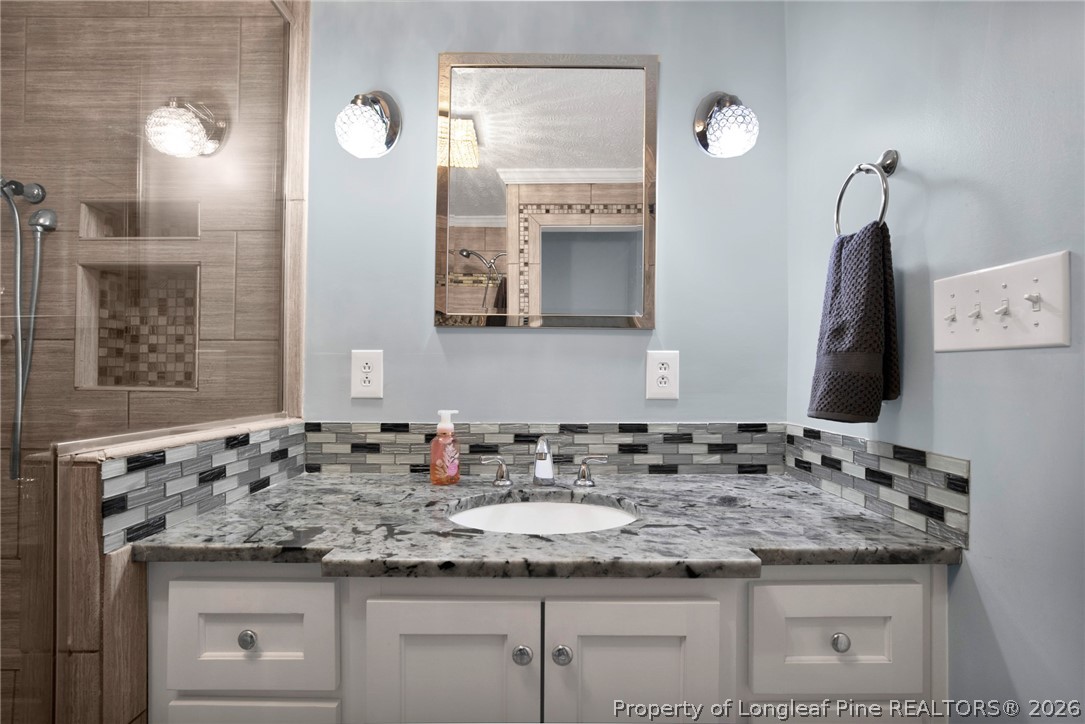 1064 Bainbridge Road Stedman, NC 28391 - Photo 32 of 46 a bathroom with a sink and a mirror