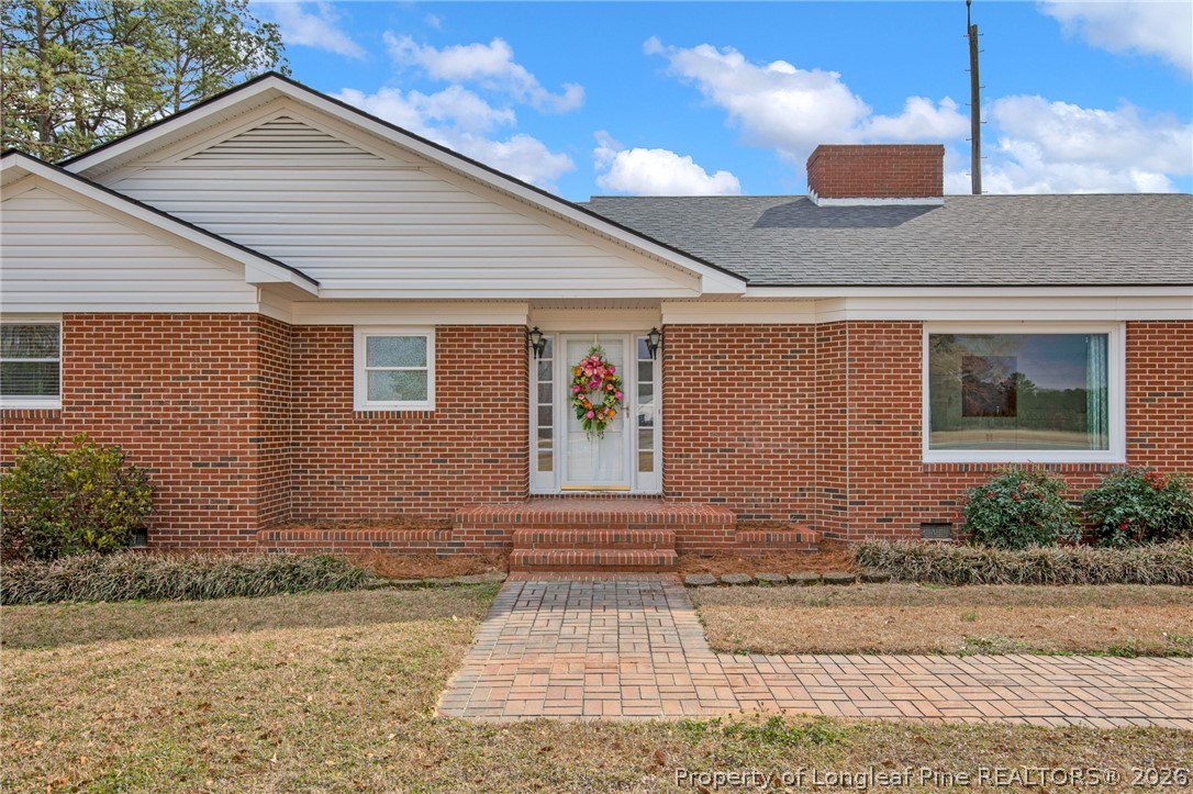 1064 Bainbridge Road Stedman, NC 28391 - Photo 5 of 46 a front view of a house with a yard