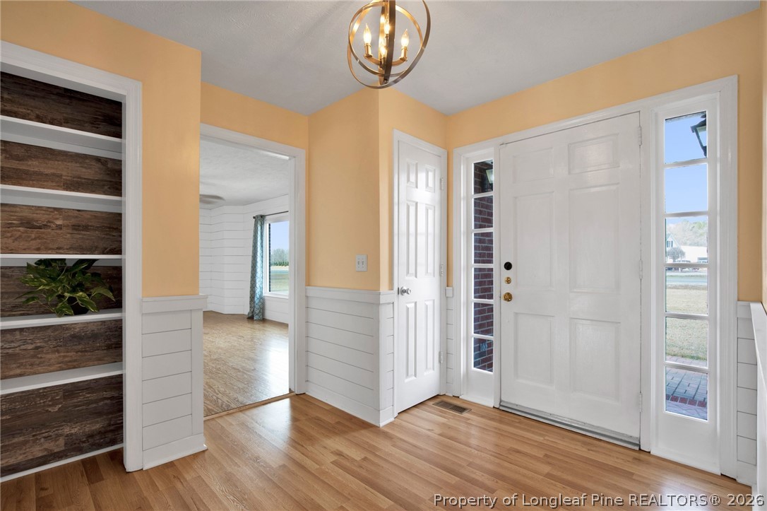 1064 Bainbridge Road Stedman, NC 28391 - Photo 6 of 46 wooden floor in an empty room and a window