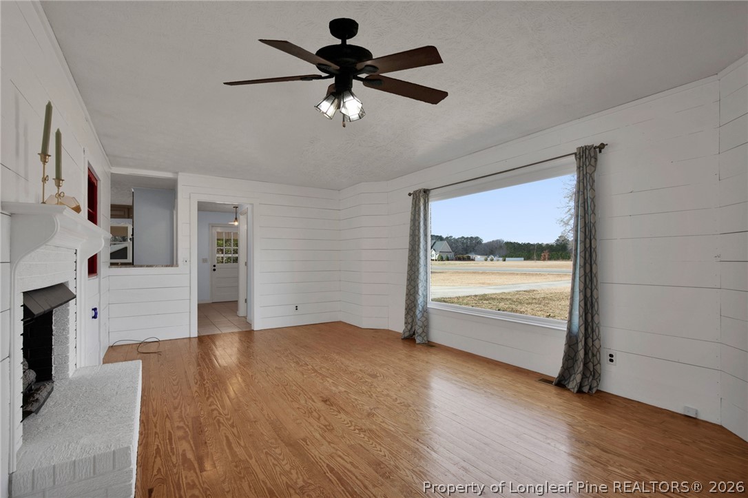 1064 Bainbridge Road Stedman, NC 28391 - Photo 7 of 46 a view of an empty room with window and wooden floor