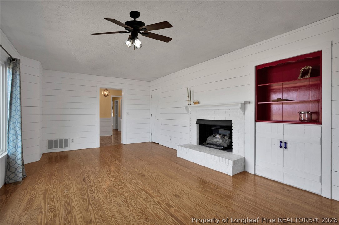 1064 Bainbridge Road Stedman, NC 28391 - Photo 9 of 46 a view of a livingroom with a fireplace and a chandelier fan
