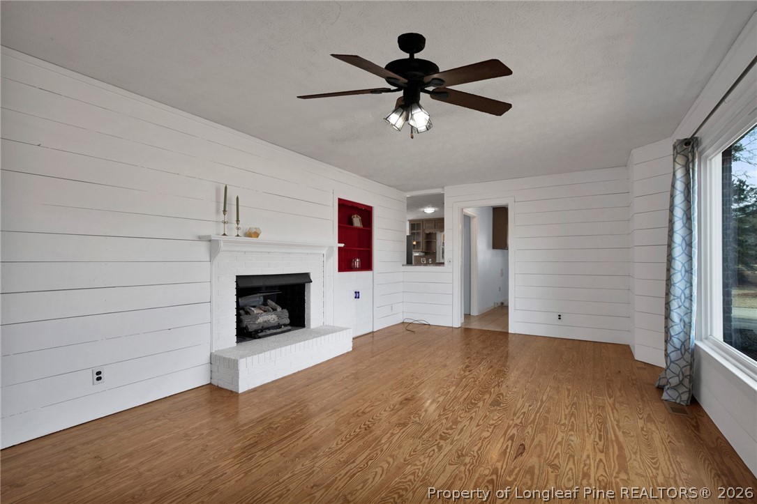 1064 Bainbridge Road Stedman, NC 28391 - Photo 10 of 46 a view of a livingroom with a ceiling fan fireplace and window
