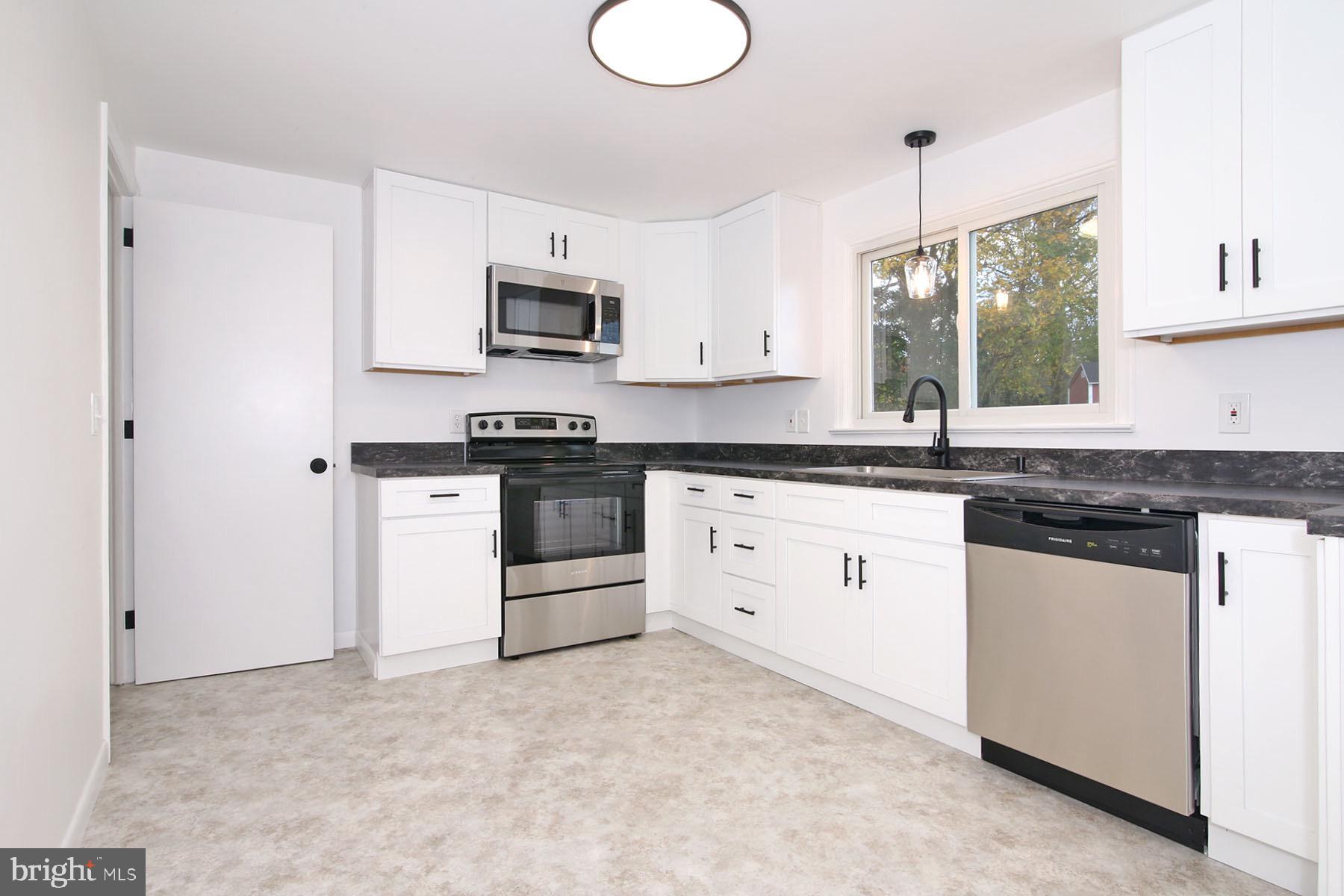 1011 State Drive Lebanon, PA 17042 - Photo 14 of 34 a kitchen with stainless steel appliances granite countertop a stove a sink and white cabinets