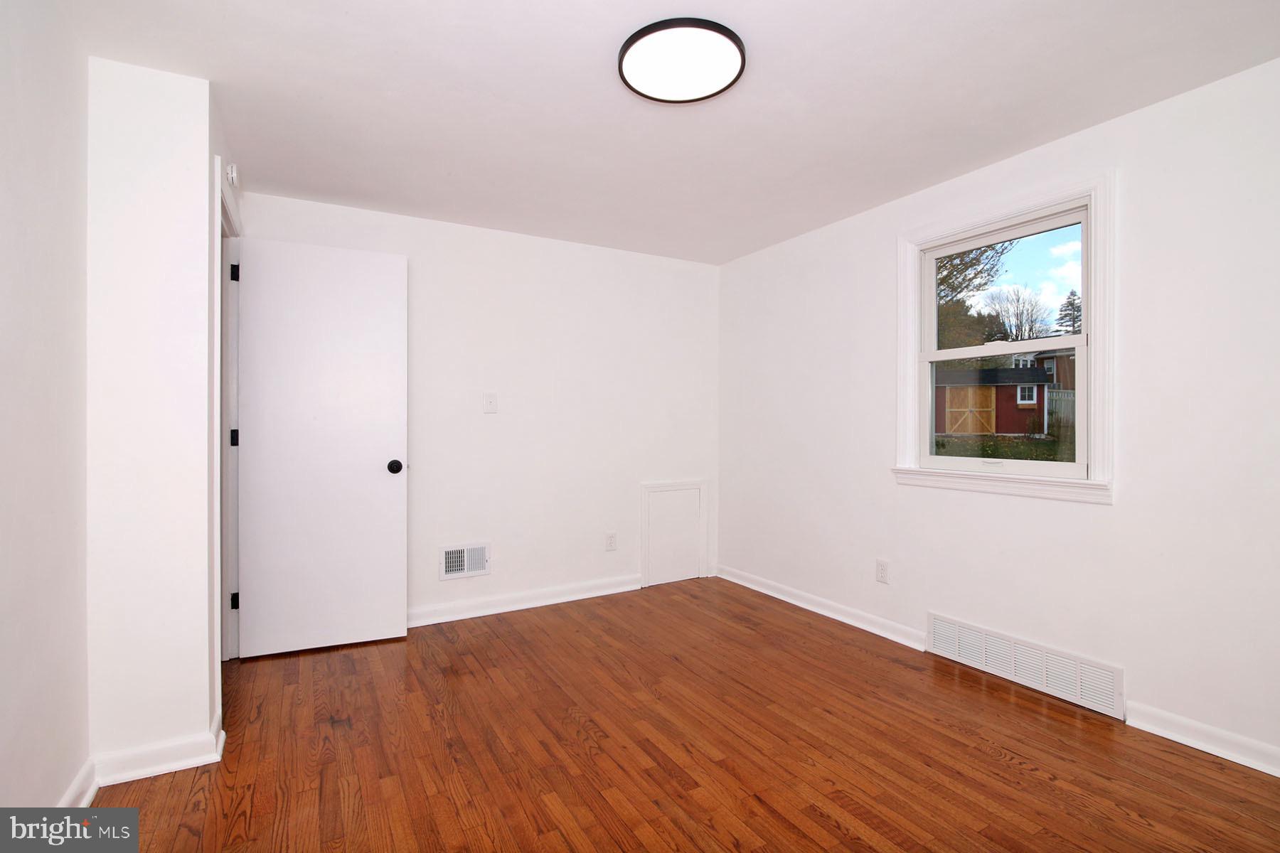 1011 State Drive Lebanon, PA 17042 - Photo 17 of 34 an empty room with wooden floor and windows