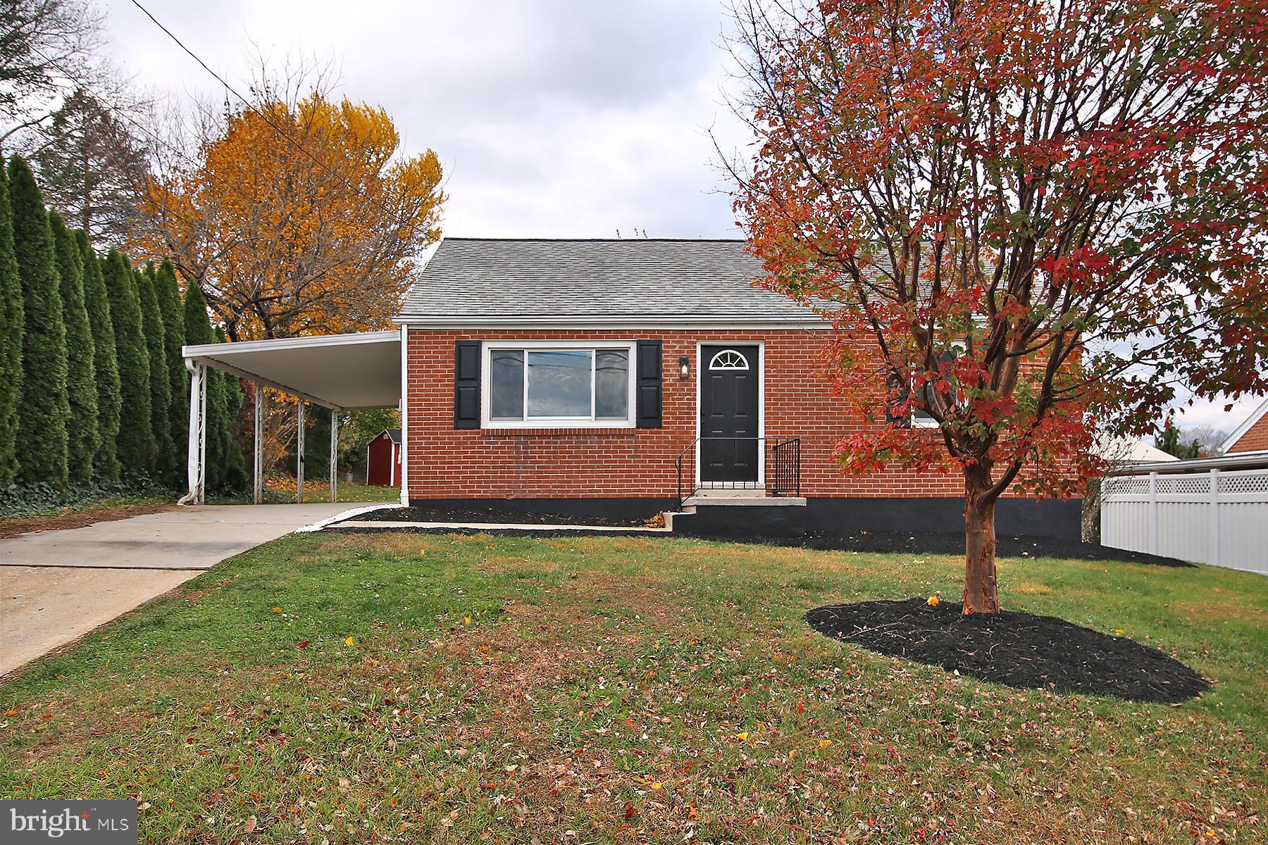 1011 State Drive Lebanon, PA 17042 - Photo 2 of 34 a front view of a house with a garden and tree
