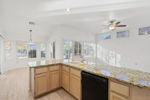 a large room with wooden floor and a window