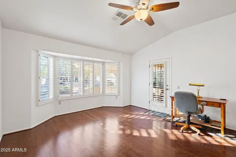 a view of a livingroom with furniture and a ceiling fan