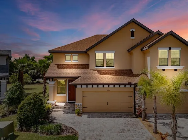 a front view of a house with a yard and garage