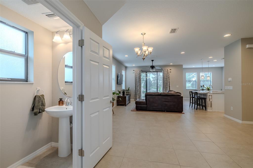 4730 Wandering Way Wesley Chapel, FL 33544 - Photo 12 of 61 a view of a livingroom with furniture and a chandelier