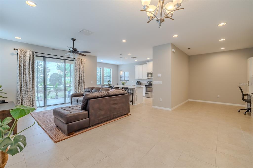 4730 Wandering Way Wesley Chapel, FL 33544 - Photo 13 of 61 a living room with furniture and a large window