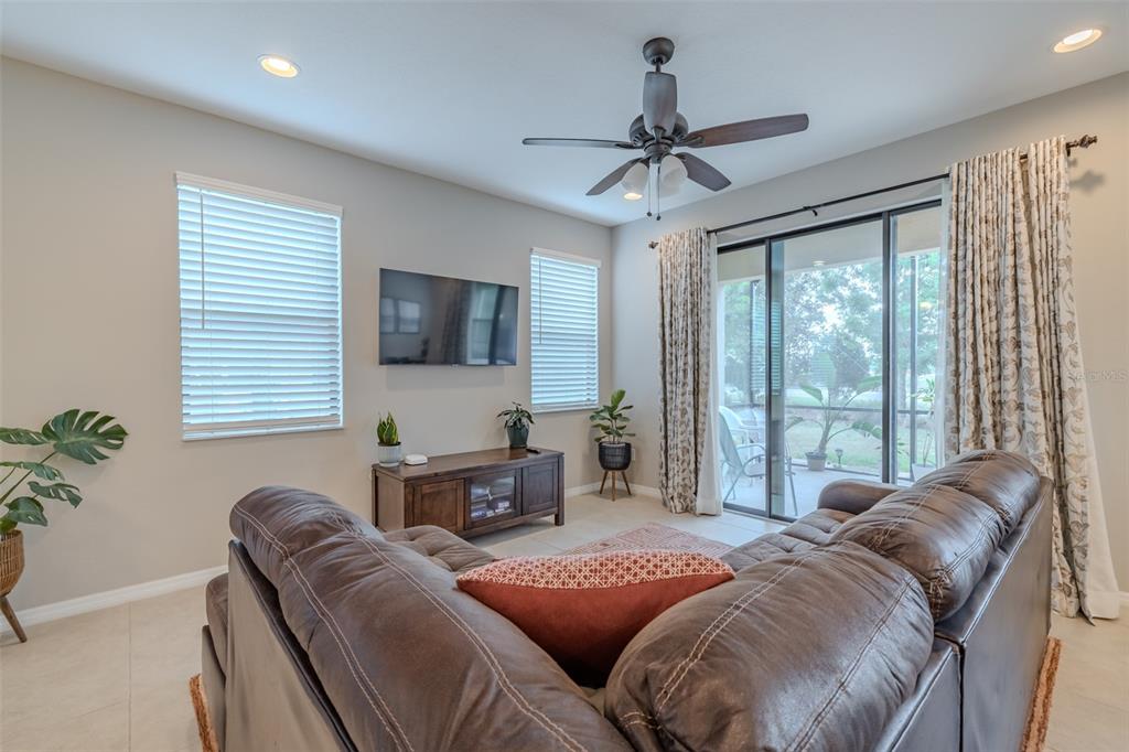 4730 Wandering Way Wesley Chapel, FL 33544 - Photo 15 of 61 a bedroom with a large bed and a large window